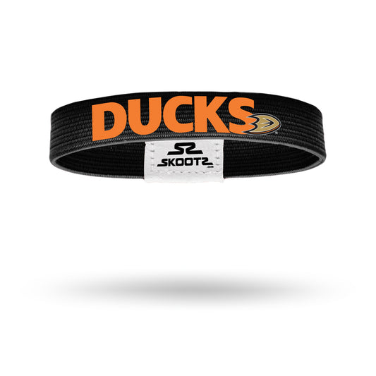 Wristband featuring a striking contrast of black and orange colors. The wristband is made of a stretchy material, allowing it to comfortably fit various wrist sizes. The dominant color is black, with vibrant orange "ducks" patterned across its surface. Perfect for casual wear or adding a pop of color to any outfit.